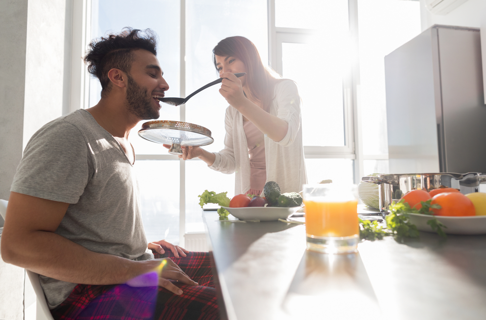 woman feeding husband breakfast