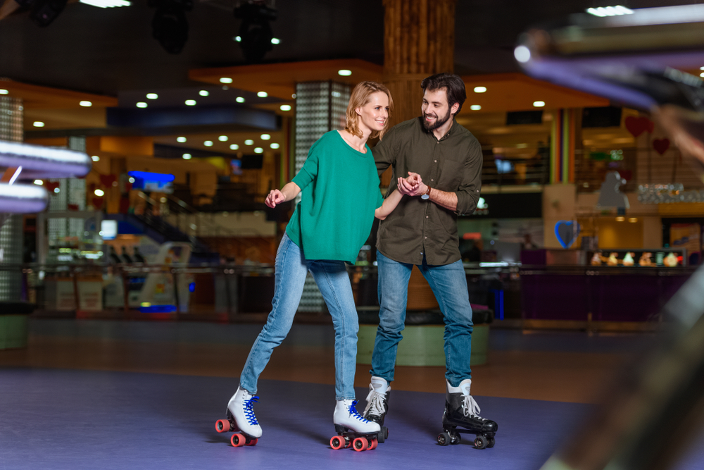 Couple holding hands while roller skating