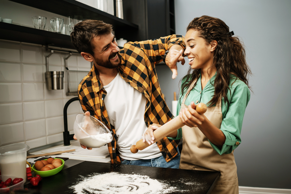 Couple laughing while baking