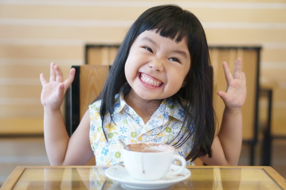 Little girl excited with hot coco