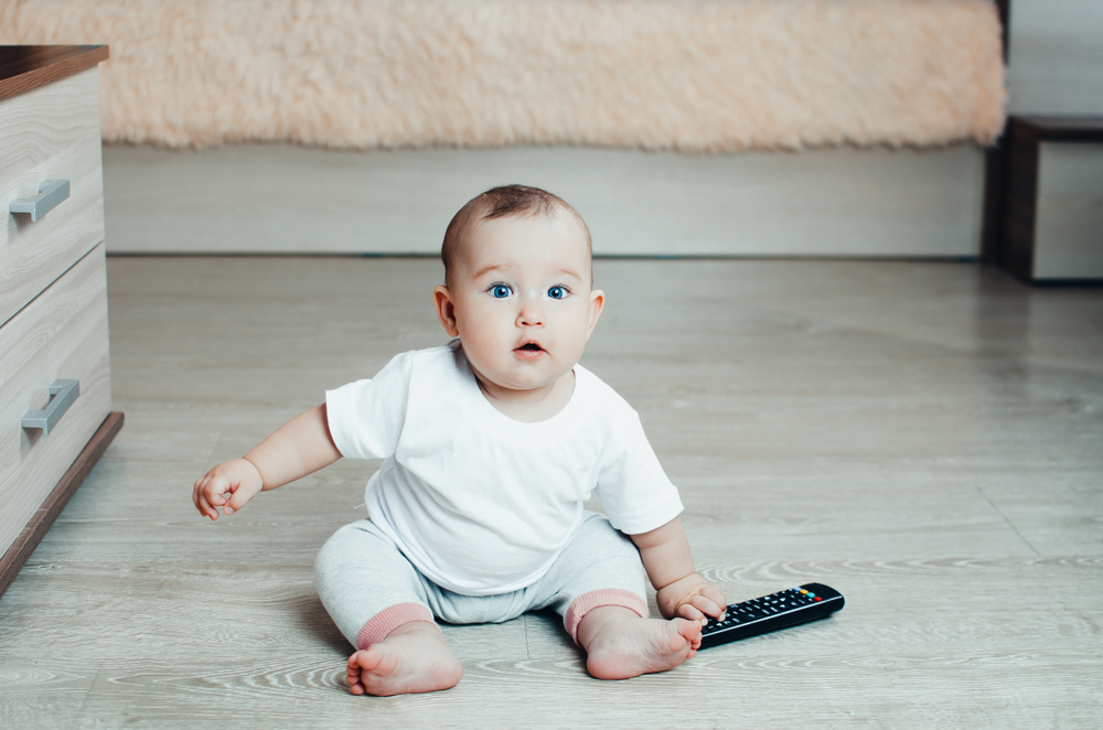 Little baby with a remote