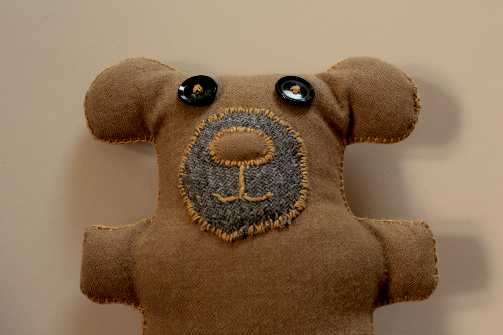 Close up of a homemade teddy bear with button eyes