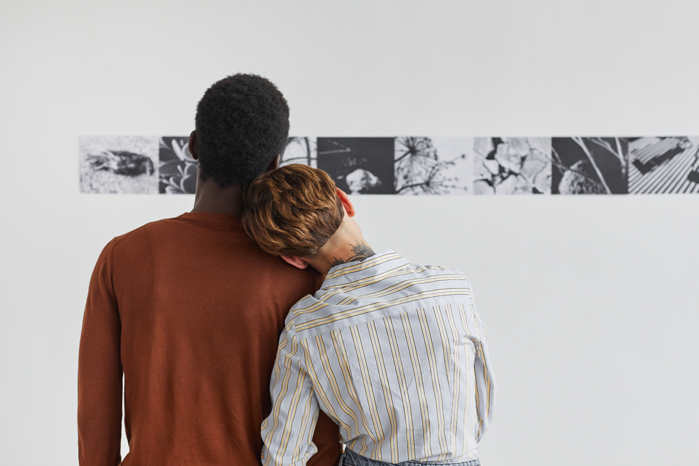 Two people looking at art on the wall
